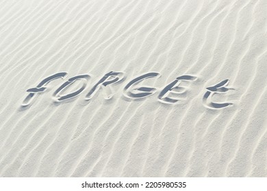 Forget Written With Finger On White Sand. Bad Memory Concept, Word On Sand