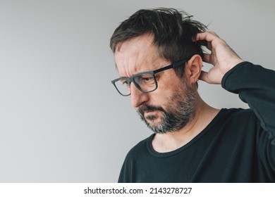 Forgetfulness - Forgetful Mid-adult Man With Eyeglasses Indoors, Trying To Remember