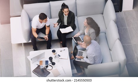 Forging Business Connections That Break The Glass Ceiling. High Angle Shot Of A Group Of Businesspeople Having A Meeting At A Conference.