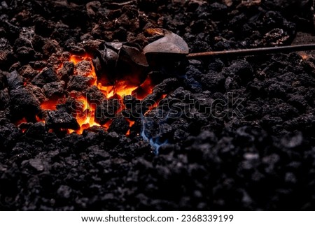 forging metal in blacksmith workshop