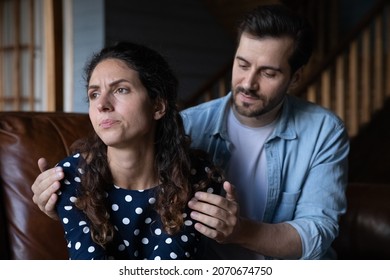 Forgive me please. Guilty young husband hug shoulder of offended wife ask forgiveness apologize after quarrel conflict fight. Millennial man try to make peace with stubborn sulky woman admit his fault