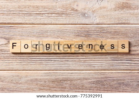 forgiveness word written on wood block. forgiveness text on table, concept.