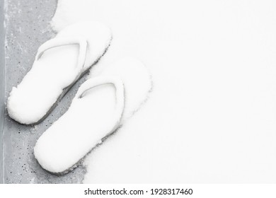 Forgotten Flip Flops In The Snow. Unexpected Weather Concept.