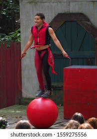 FORISTELL, MISSOURI - OCTOBER 5, 2019: Actor Jumps Rope While Balancing On A Ball With A Tennis Racket Around His Waist At The St. Louis Renaissance Faire