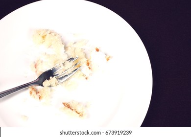 Fork And Cake Crumbs On Plate, View From Above