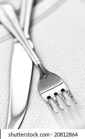 Fork And Knife Close Up On White Napkin