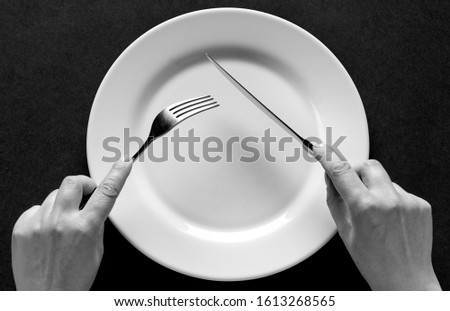 Similar – Image, Stock Photo Hand with cutlery and a bowl of green salad. Top view.