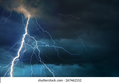 Fork lightning striking down during summer storm.