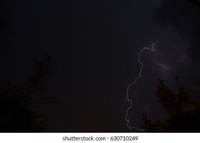 Fork lightning striking down during summer storm