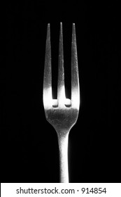 a fork on a black background