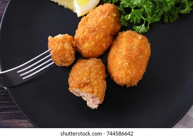 Fork With Piece Of Salmon Croquette On Plate, Closeup