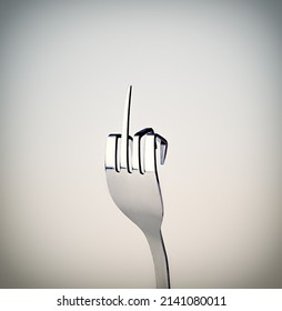 Fork . A Fork Showing A Rude Gesture While Isolated On Grey.