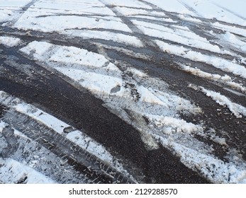 A Fork Or Siding From A Roundabout. Snowdrifts On The Side Of The Road. Bad Weather And Traffic. Snow On Asphalt. Difficult Driving Conditions. Winter Slosh On The Road. Braking Distance Of A Car.