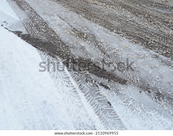 A fork or siding from a roundabout. Snowdrifts on\
the side of the road. Bad weather and traffic. Snow on asphalt.\
Difficult driving conditions. Winter slosh on the road. Braking\
distance of a car.
