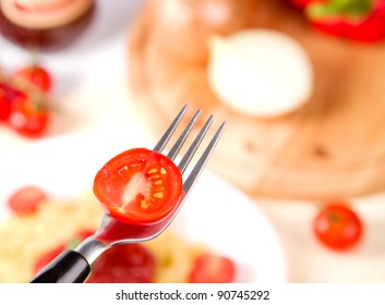 fork with slice of tomato