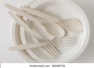 Fork and spoon with disposable paper plate for party