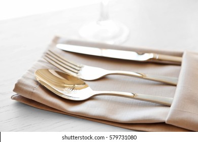 Fork, Spoon And Knife On Linen Napkin