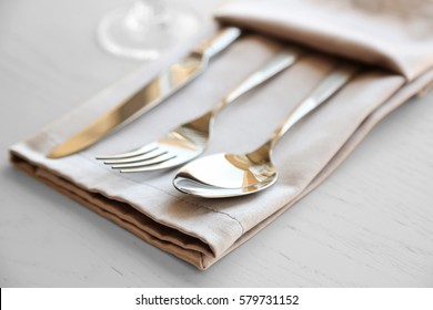 Fork, Spoon And Knife On Linen Napkin