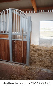 A fork stands in front of an empty horse box