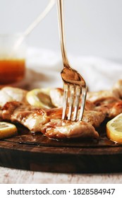 Fork Stuck In A Piece Of A Chicken Dinner With Honey Mustard Drizzle On A Dark Rustic Board