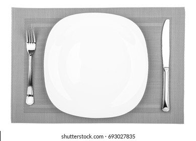 Fork, Table Knife And Empty White Plate On A Placemat Closeup, Top View