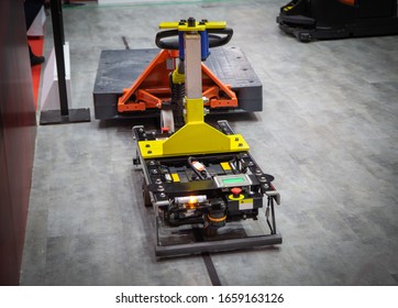 Forked Automatic Guided Vehicles (AGV) Handling Material In Warehouse