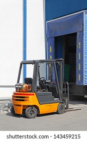 Forklift at distribution warehouse loading dock