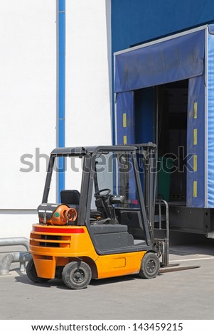 Forklift at distribution warehouse loading dock