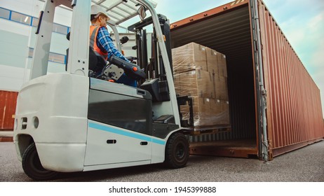 Forklift Driver Loading A Shipping Cargo Container With A Full Pallet With Carboard Boxes In Logistics Operations Port Terminal.