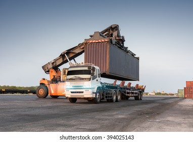 Forklift handling container box loading at the docks port from train to truck, Cargo shipping import or export transportation concept