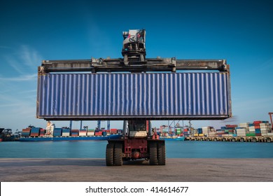 Forklift Handling Container Box Loading At Port Cargo At Sunset