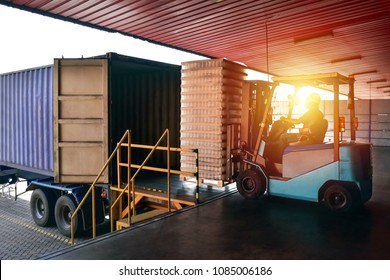 Forklift handling empty tin cans from container into warehouse. Distribution, Logistics Import Export, Warehouse operation, Trading, Shipment, Delivery concept. - Powered by Shutterstock