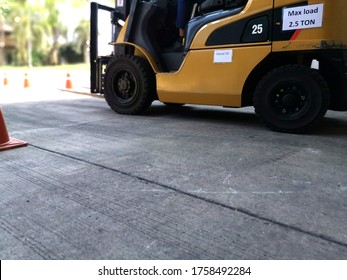 Forklift Identify With Diesel Oil And Max-load 2.5 Tons On The Cement Floor And Blurred Red Traffic Cone, Outdoor Forklift Training Class In Factory