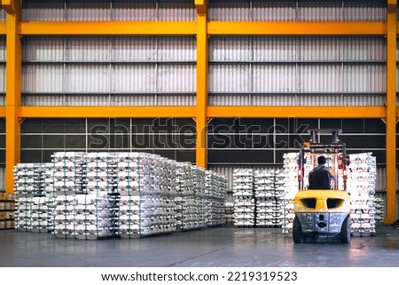 Forklift lifting cargo inside distribution warehouse. Aluminum cargo handling storage, and shipping. Logistics center. 