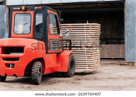 Forklift loader load lumber into a dry kiln. Wood drying in containers. Industrial concept