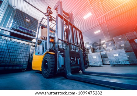 Forklift loader. Pallet stacker truck equipment at warehouse. Background