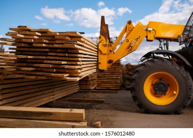 Forklift loads the boards in the lumber yard - Powered by Shutterstock