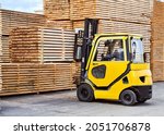 Forklift loads lumber into stacks at the finished product warehouse