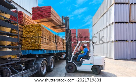 Forklift operator handling wooden pallets in port