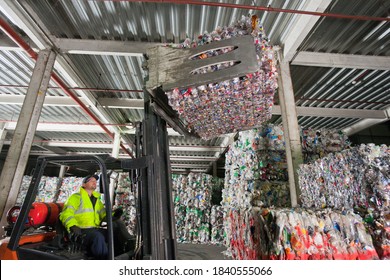 Forklift Operator Lifting Bale Of Recycled Plastic In Recycling Plant