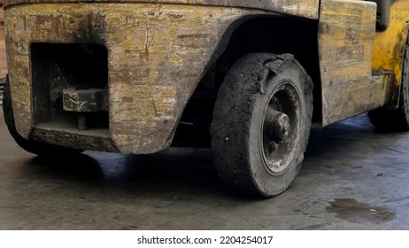 Forklift tires in the factory With torn tire condition and not safe to use. Broken car on the road with damaged tire and disk. closeup damaged 18 wheeler semi truck burst tires by highway street. - Shutterstock ID 2204254017