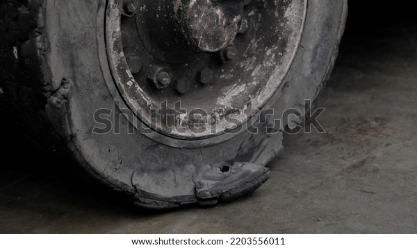 Forklift tires in the factory With torn tire
condition and not safe to use. Broken car on the road with damaged
tire and disk. closeup damaged 18 wheeler semi truck burst tires by
highway street.