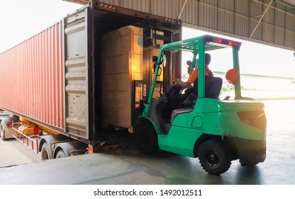 Forklift Tractor Loading Package Boxes Into Shipping Container At Dock Warehouse. Cargo Shipment Loading Truck. Supply Chain Freight Truck. Industry Warehouse Logistics Transportation.