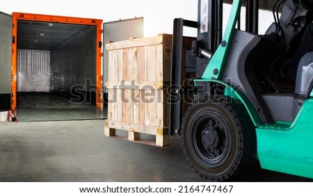 Forklift Tractor Loading Wooden Crate Boxes into Cargo Container. Shipping Trucks. Delivery Cargo Service. Supply Chain Goods Shipment. Warehouse Logistics Transport.