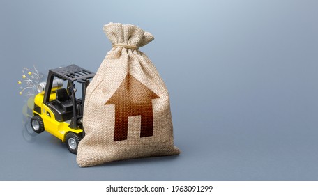 Forklift Truck Cannot Lift The Bag With House Symbol. Concept Of Inability To Maintain Housing. Repair And Renovation, Lack Of Resources. Difficulty Paying Utility Bills. Insufficient Funding