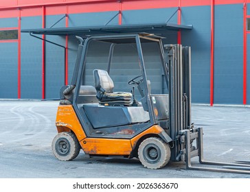 Forklift Truck In Front Of Warehouse Building