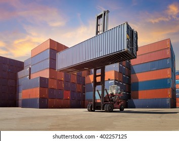 Forklift truck handling cargo shipping container box in logistic shipping yard with cargo container stack in background - Shutterstock ID 402257125