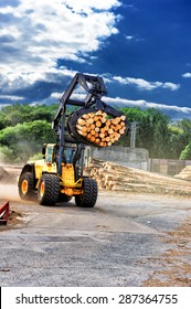 Forklift Truck Hauling Logs At Sawmill