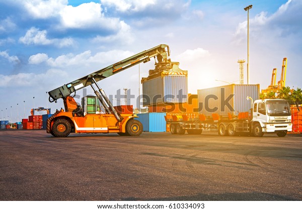 Forklift\
truck lifting cargo container shipping yard for\
transportation,import,export logistic\
industrial