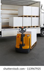 Forklift Truck Loading Pallets Of Paper In Lorry